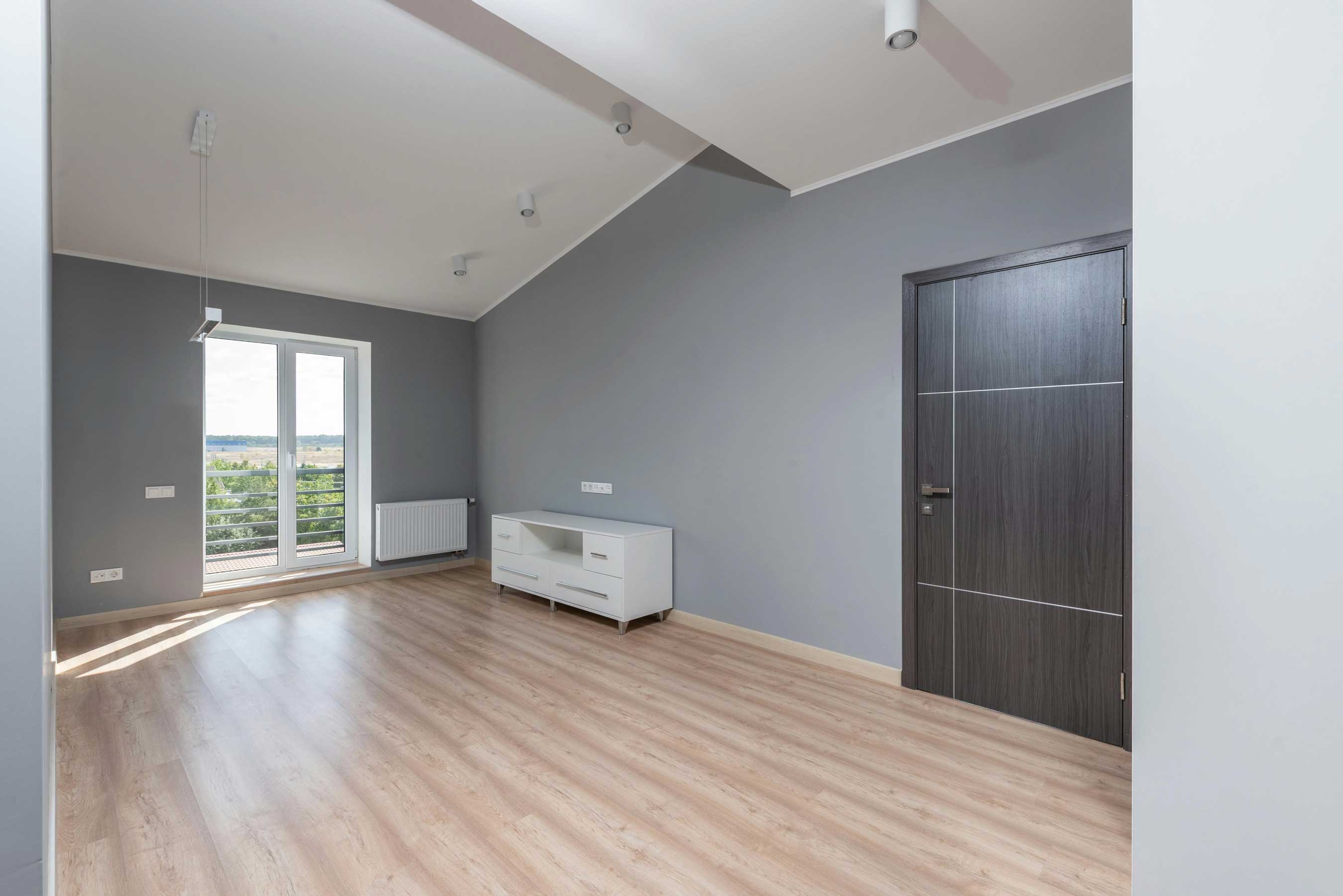 Rénovation intérieure à Ferney-Voltaire (Pays de Gex) : pièce refaite avec peinture grise et parquet clair – AK Rénovation